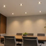 Six recessed downlights serve a commercial meeting room.