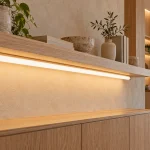 Tubular light feature integrated with an interior architectural detail