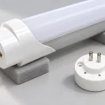 An unpowered G13 lamp and a separate closely spaced bi-pin end component on a supported surface