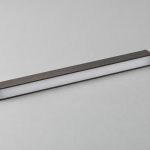 Bar shelf lighting concept with bronze housing, a continuous opal window and black connection lead
