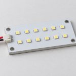 Custom LED module concept showing a rectangular white board, two LED rows, mounting holes and a two-wire connector